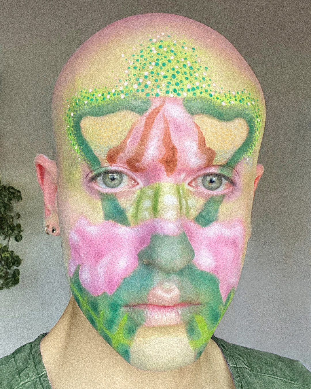 Close up portrait of Jesse Clark with artistic facepaint of a colorful fire poppy flower